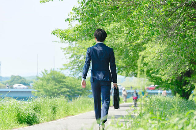 Back-view-of-a-businessman-walking-outside.jpg