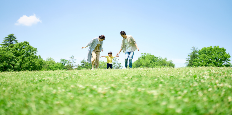 family_walking_green_park_sunny.png